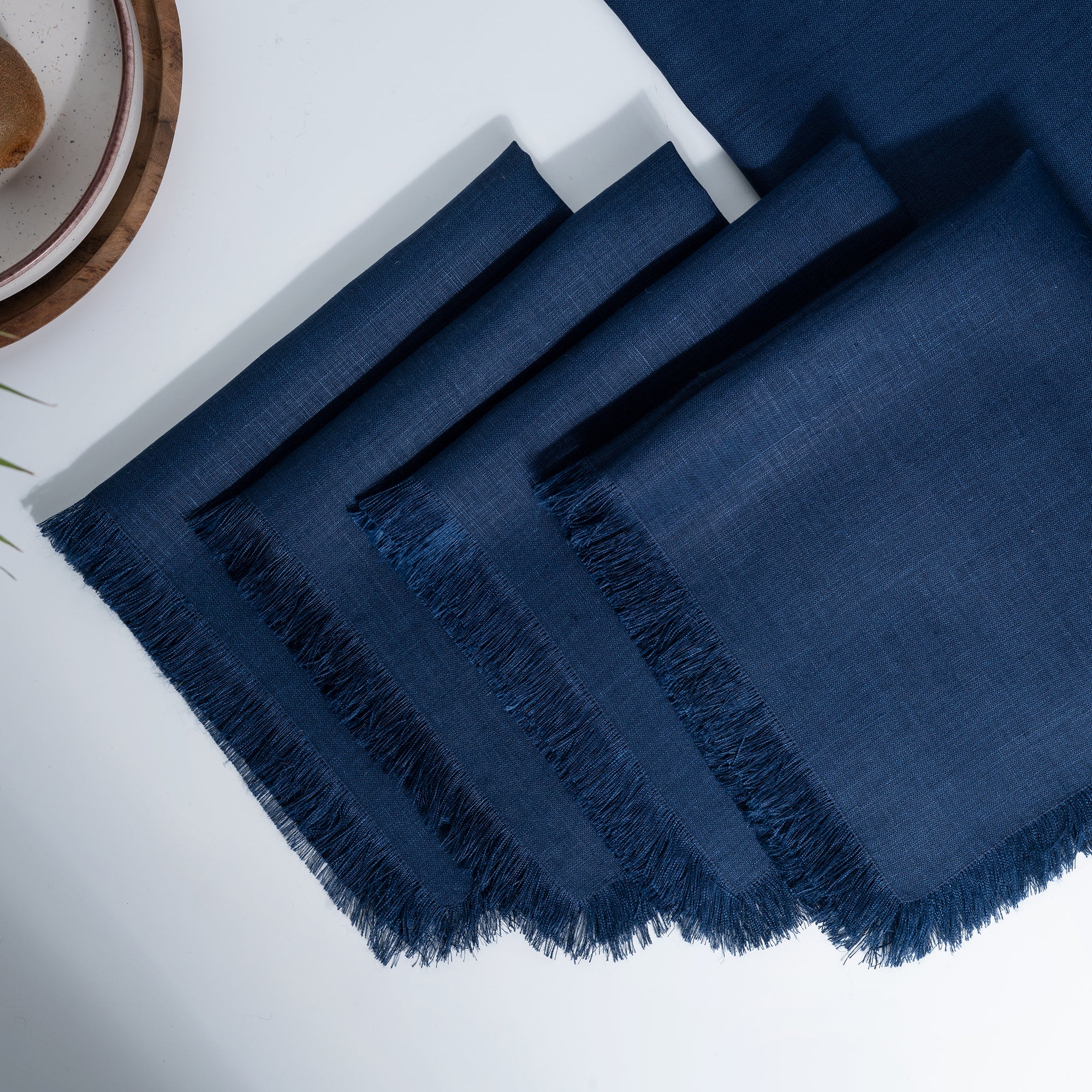Navy blue pure linen dinner napkins styled on a dining table