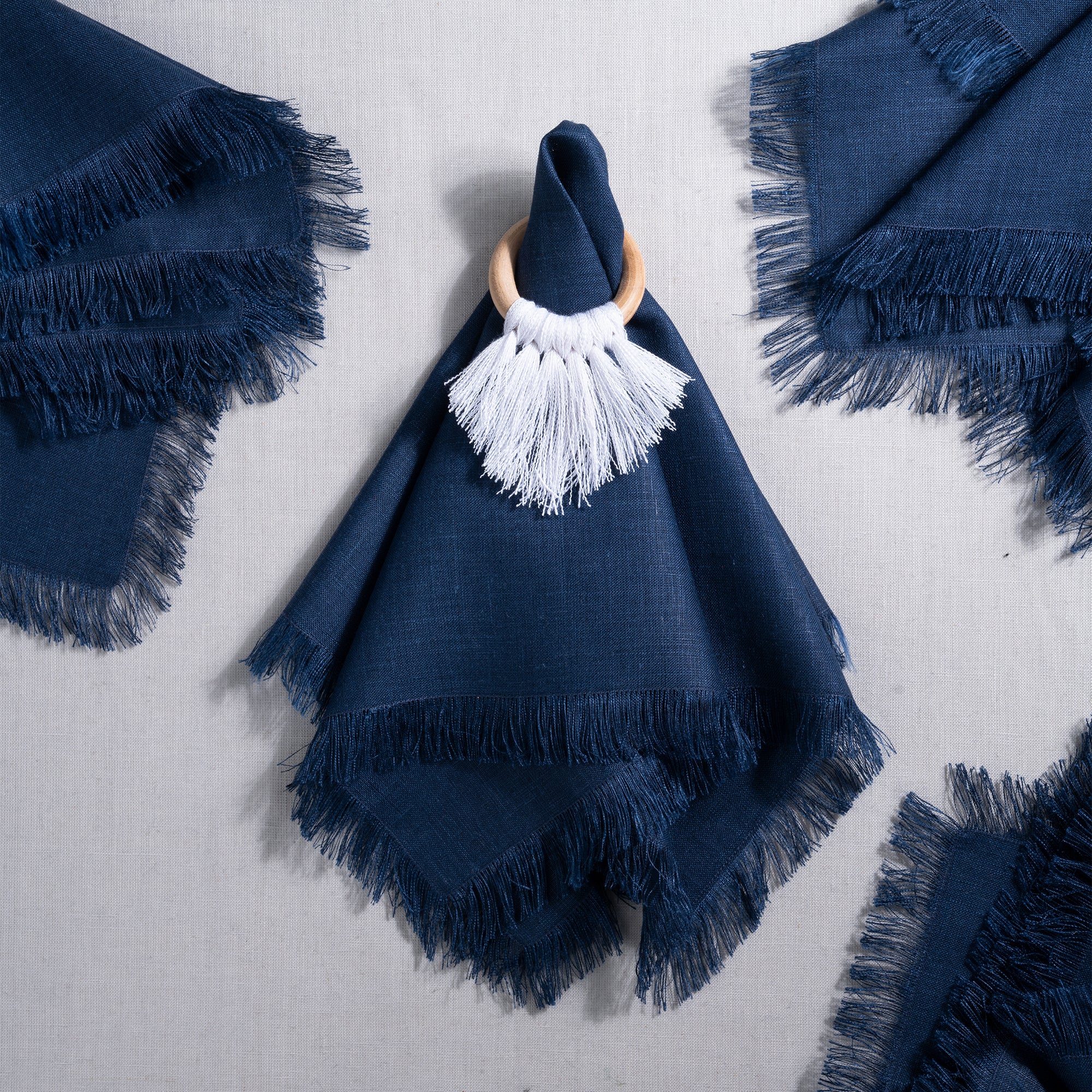 Close-up of the fringed edge on navy blue pure linen dinner napkins