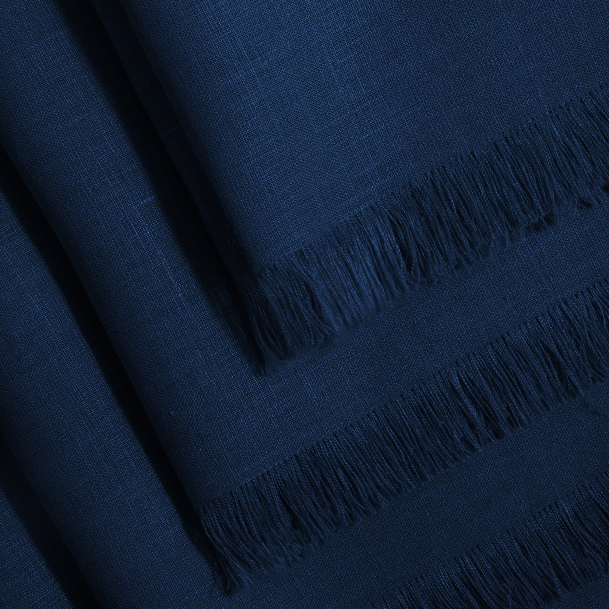 Navy blue pure linen dinner napkins folded to show fabric texture