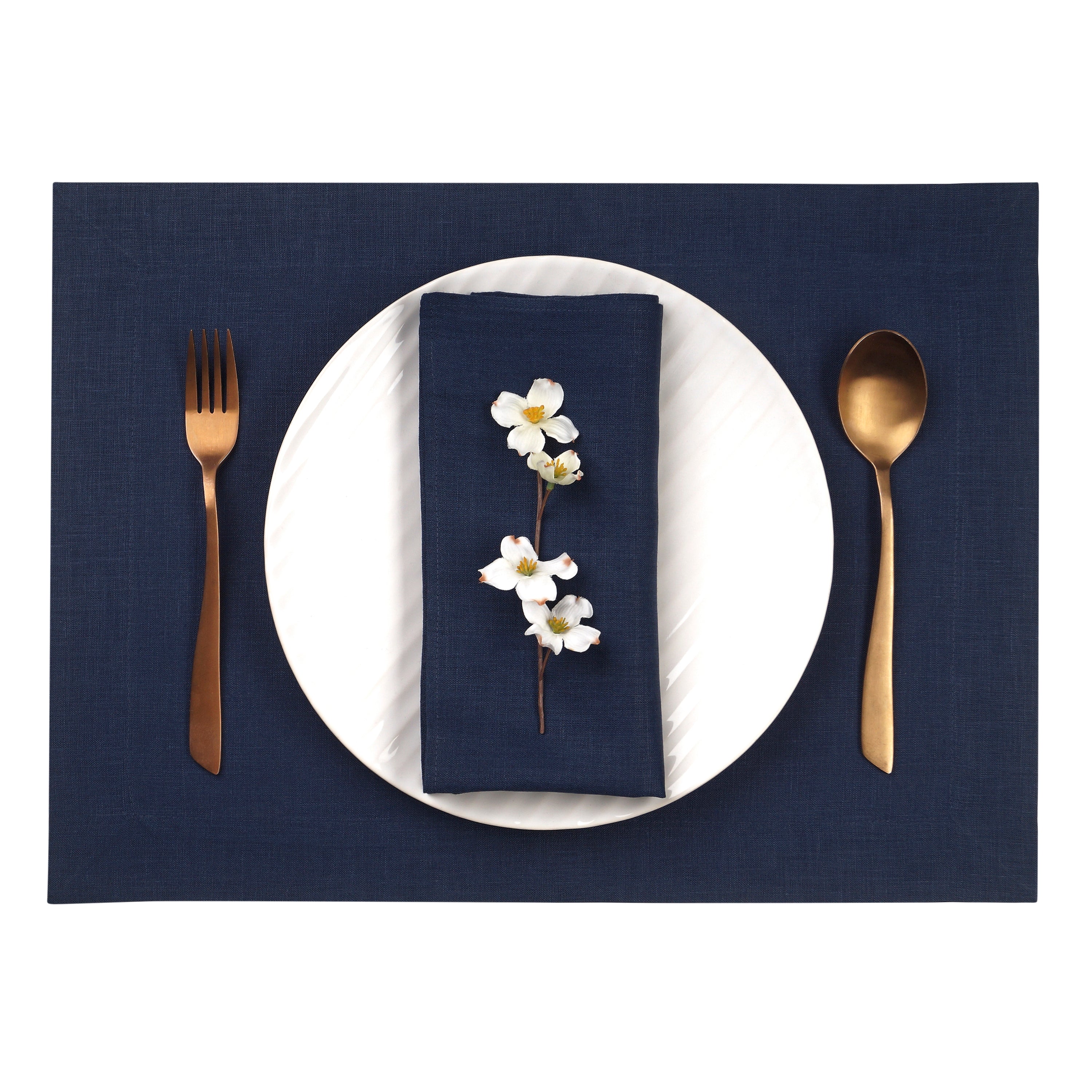 Close-up of the hemmed edge on navy blue linen placemats