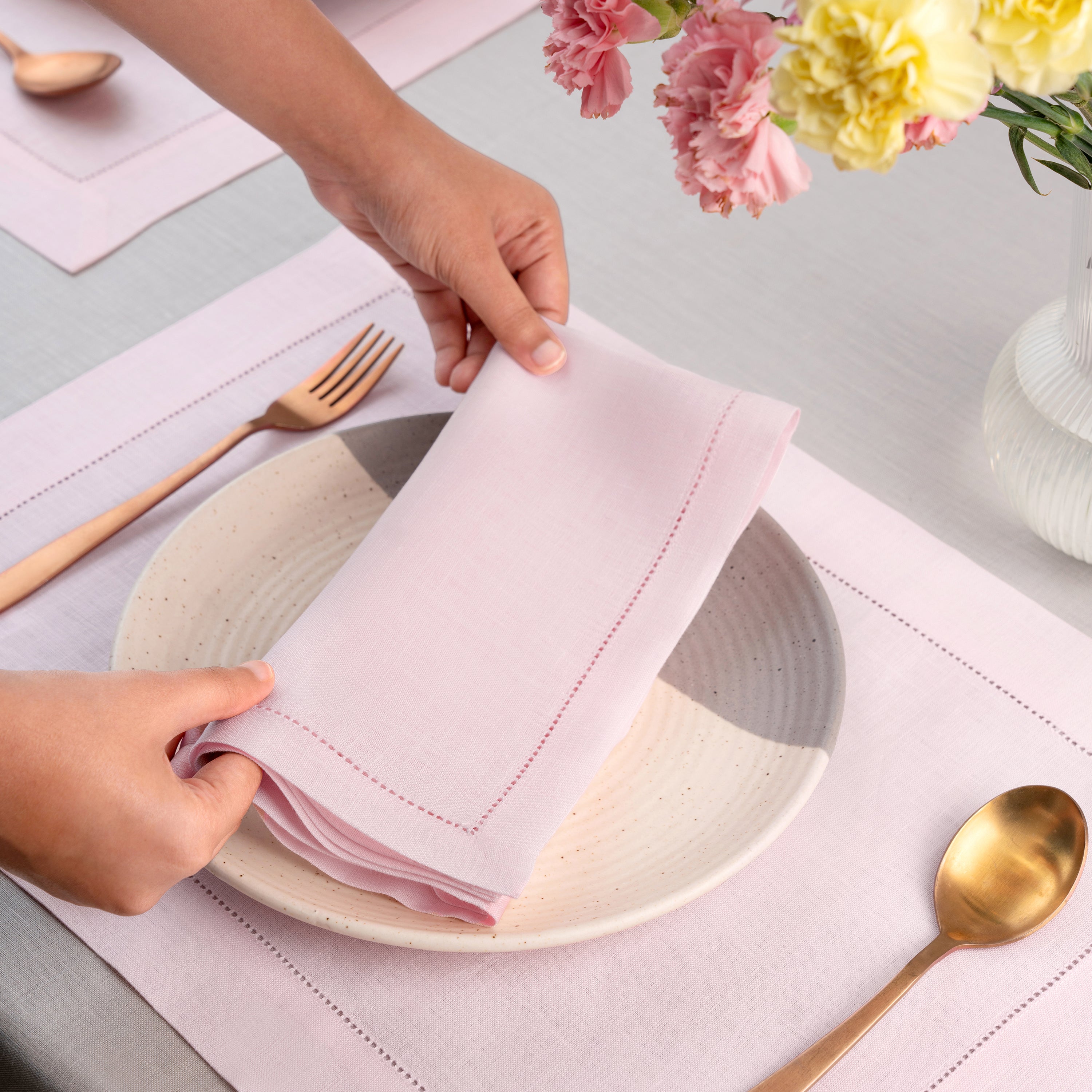 Pastel pink pure linen dinner napkins styled on a dining table