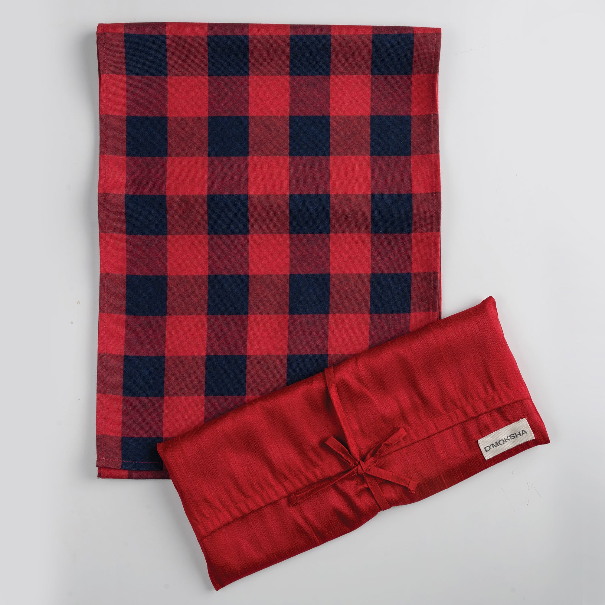 Red and navy blue linen table runner folded to show fabric texture