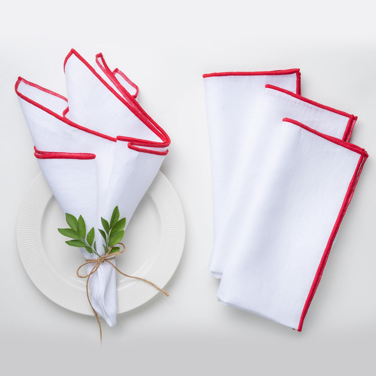 White and red pure linen dinner napkins styled on a dining table