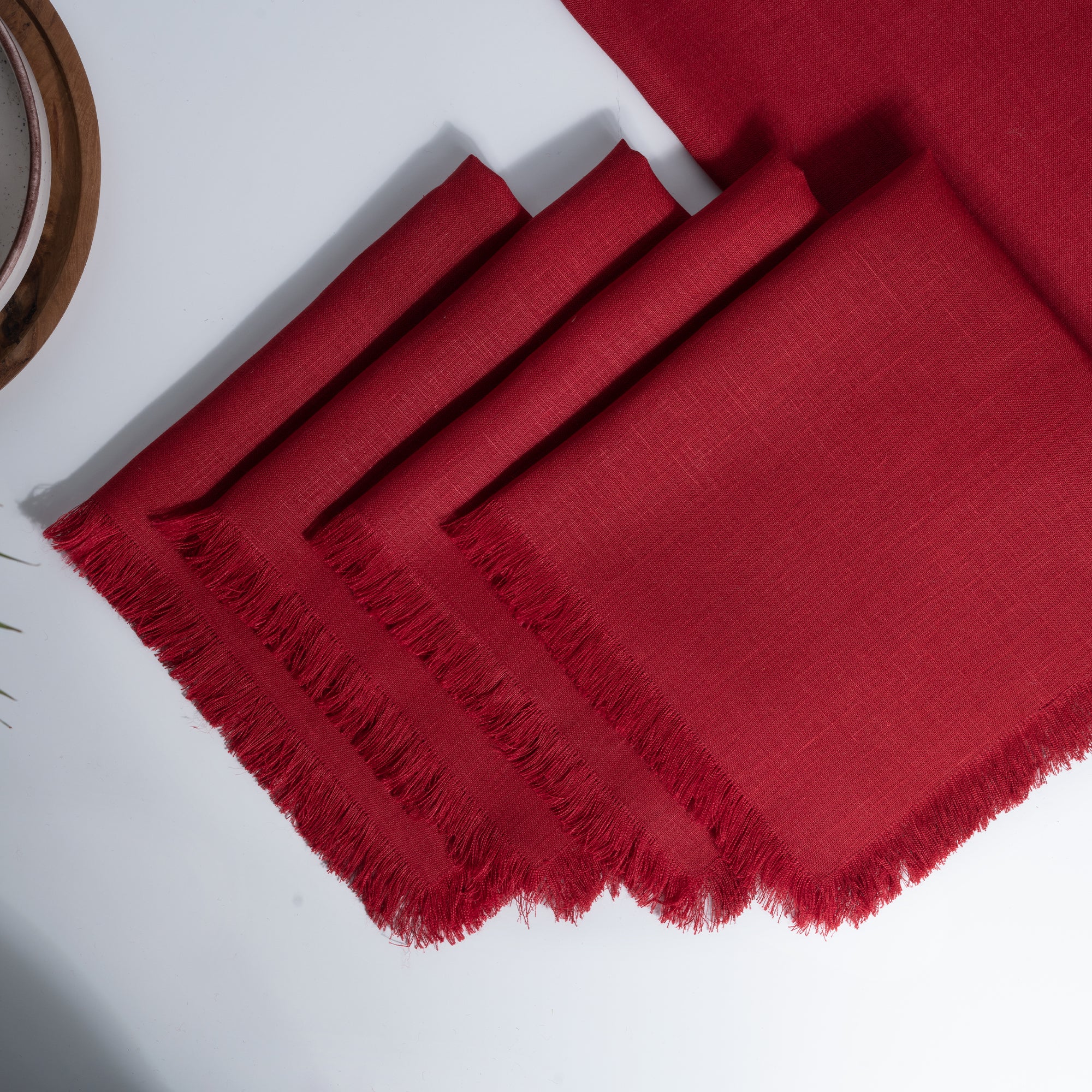 Red pure linen dinner napkins styled on a dining table