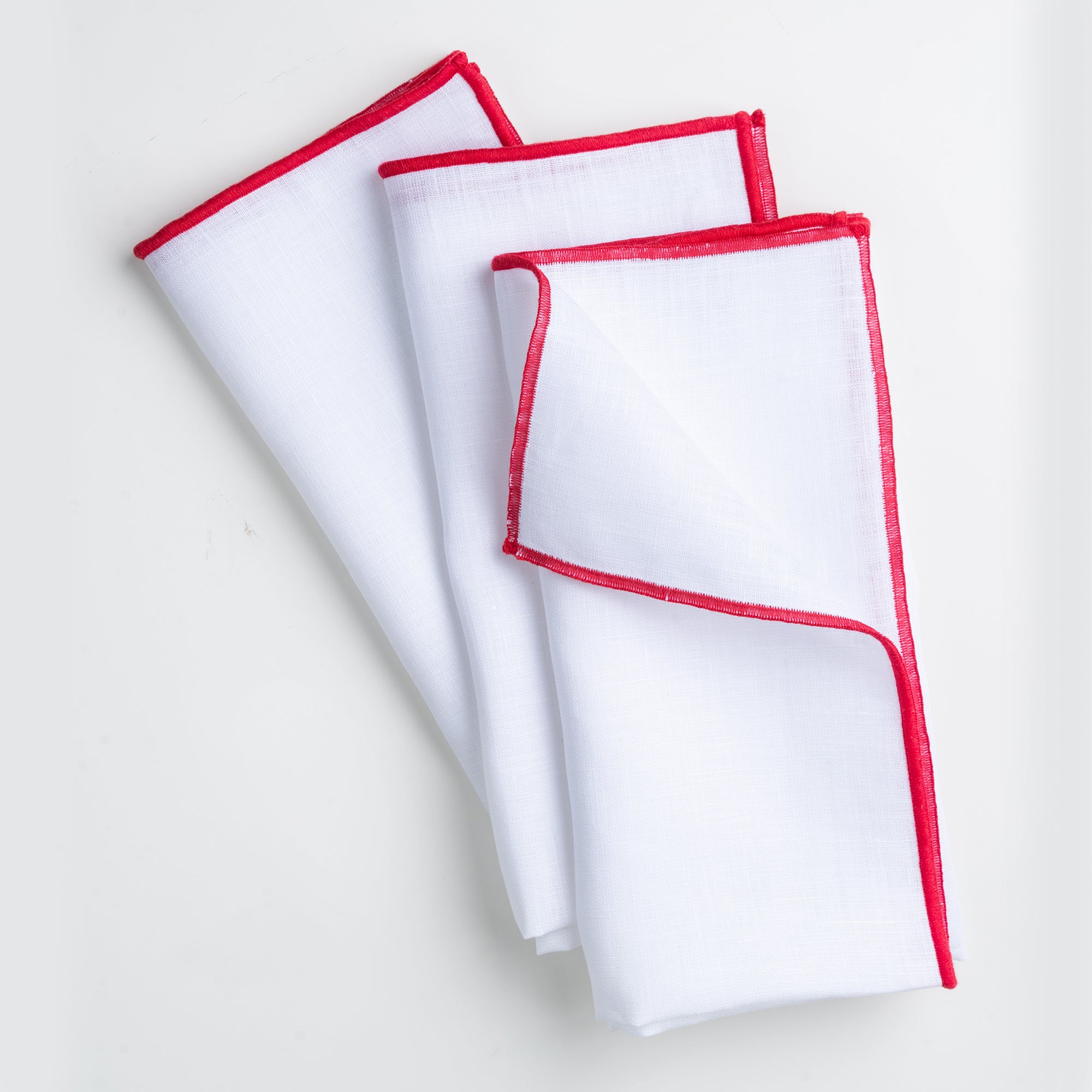 Close-up of the marrow edge on white and red pure linen dinner napkins