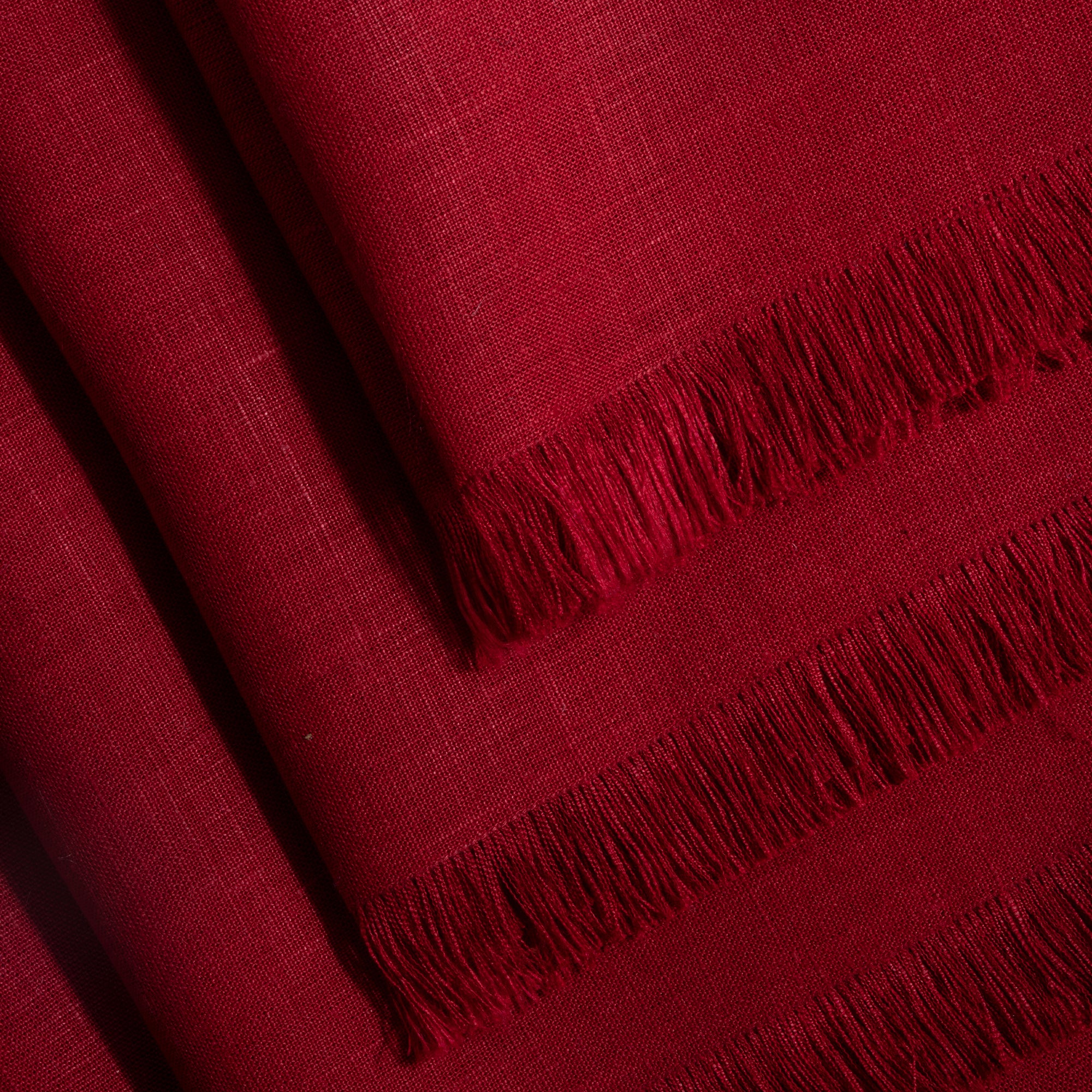 Red pure linen dinner napkins folded to show fabric texture