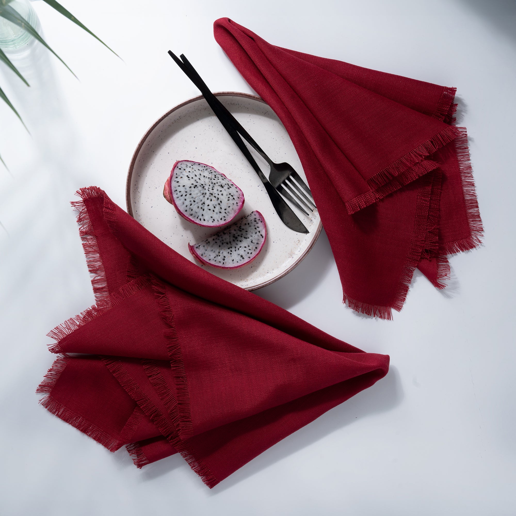 Close-up of the fringed edge on red faux linen dinner napkins