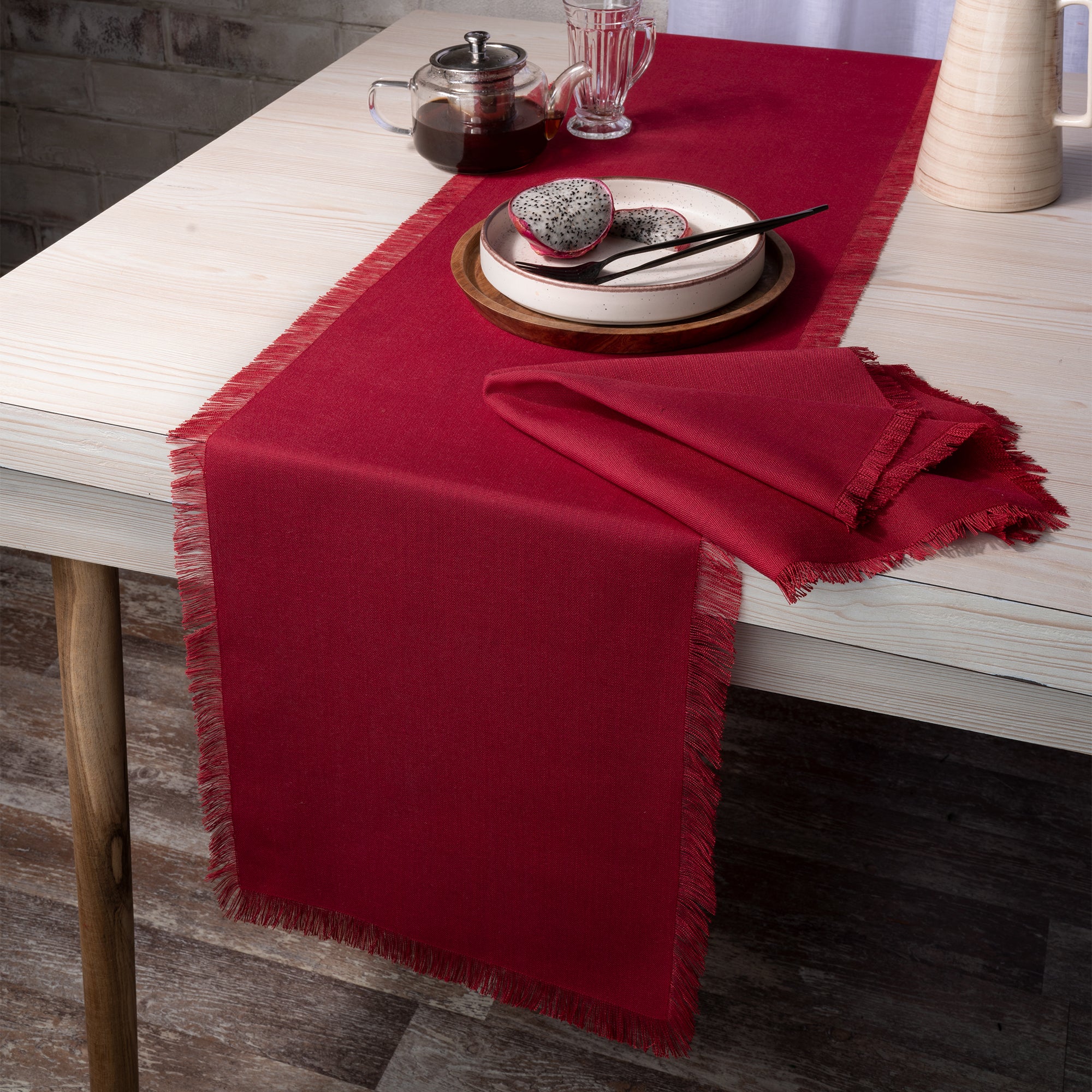 Red faux linen table runner styled on a dining table