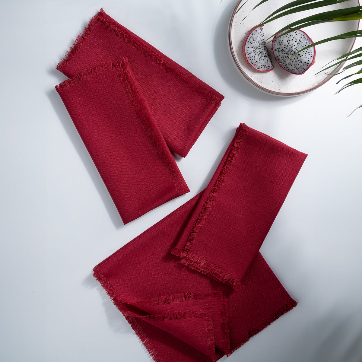 Red faux linen dinner napkins styled on a dining table