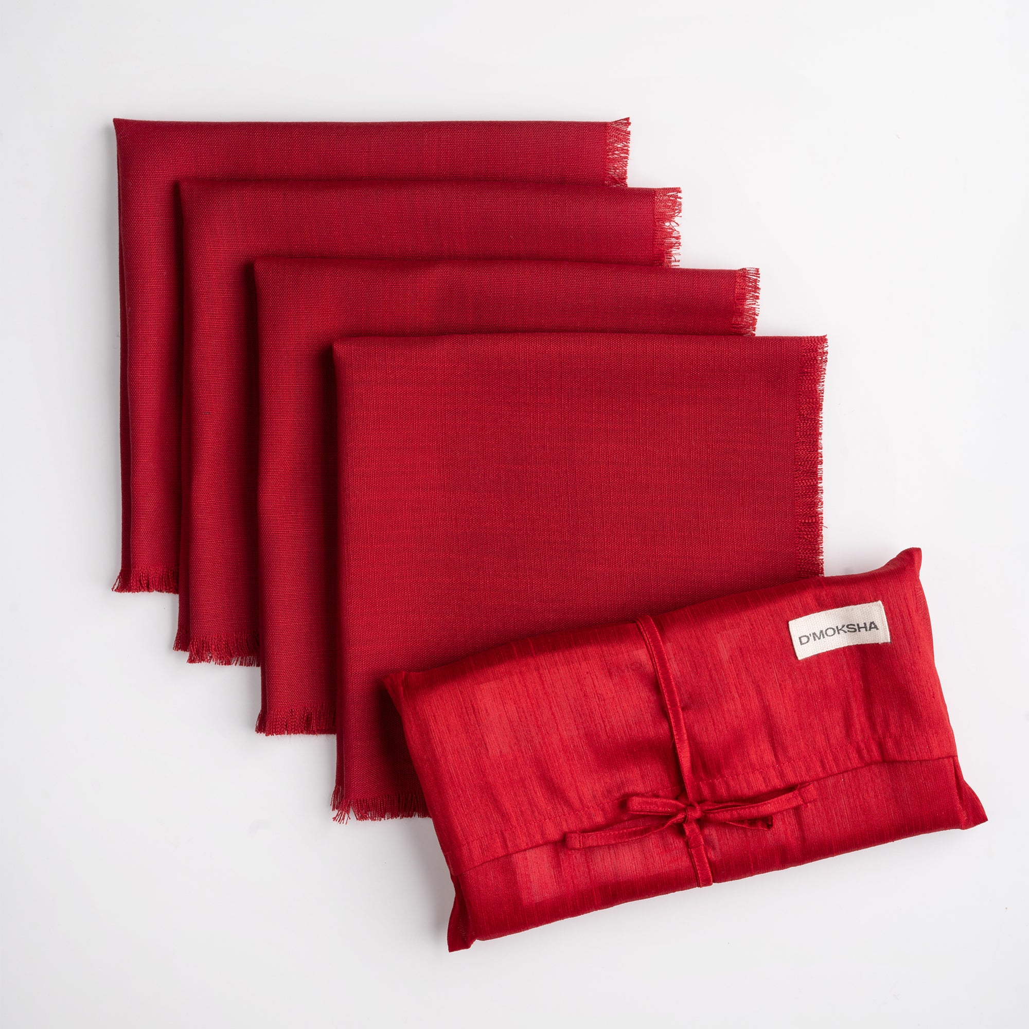 Red faux linen dinner napkins folded to show fabric texture