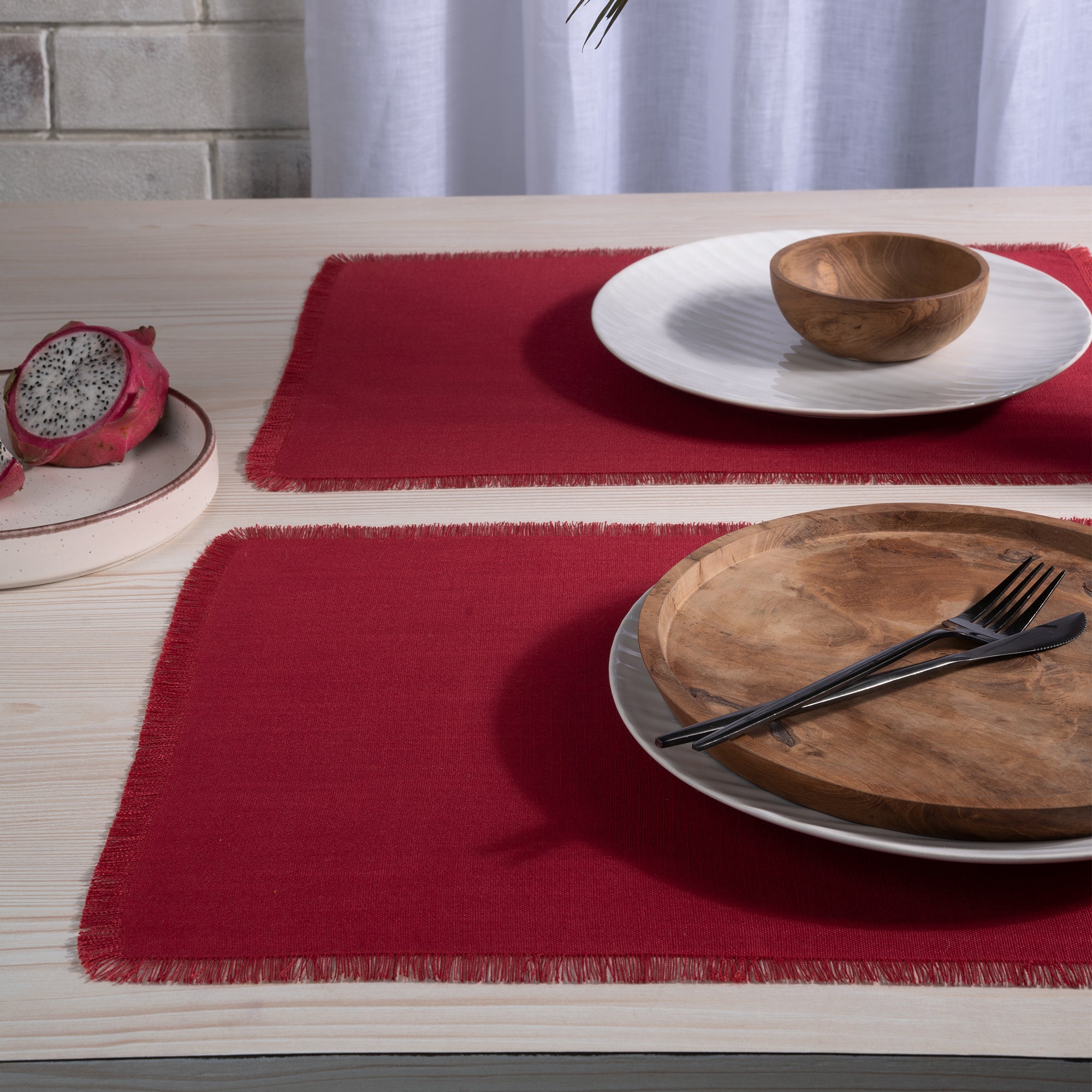 Red faux linen placemats with matching D'Moksha table linens