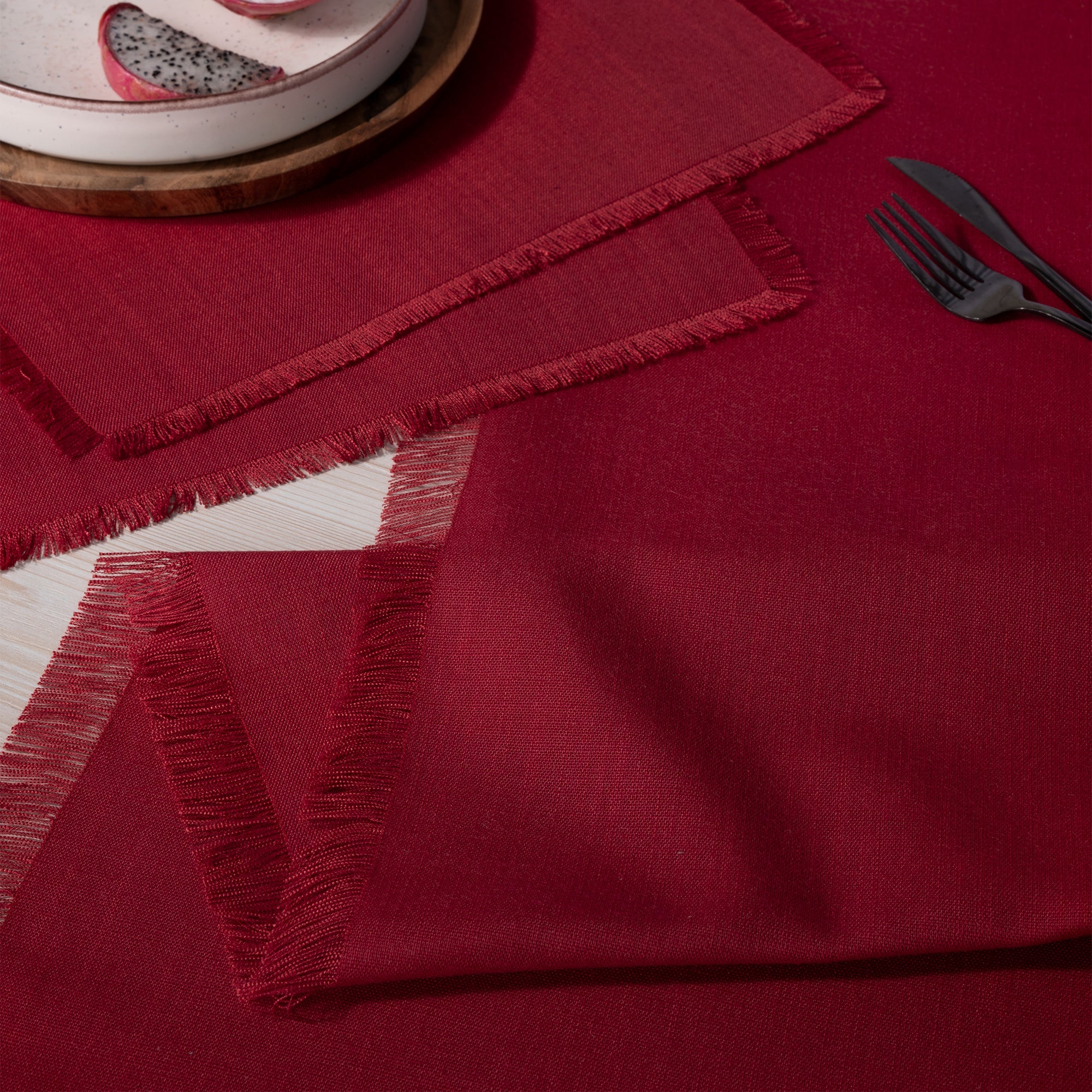 Red linen table runner with matching D'Moksha table linens