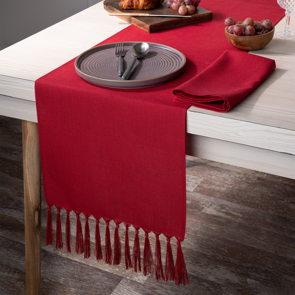 Red faux linen table runner styled on a dining table
