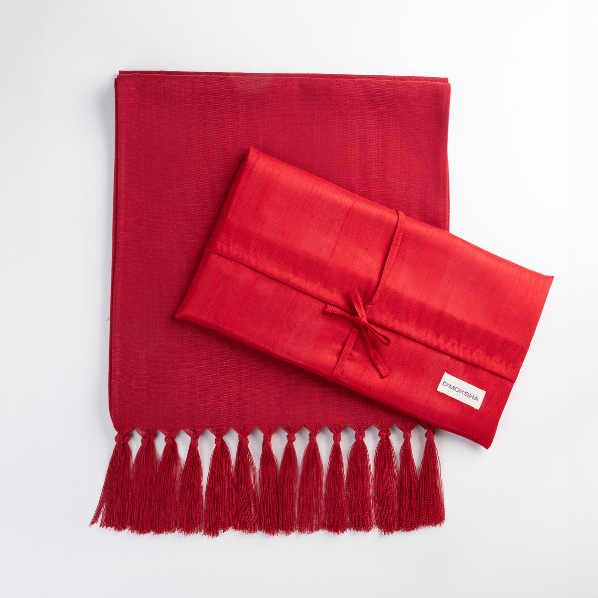 Red faux linen table runner folded to show fabric texture