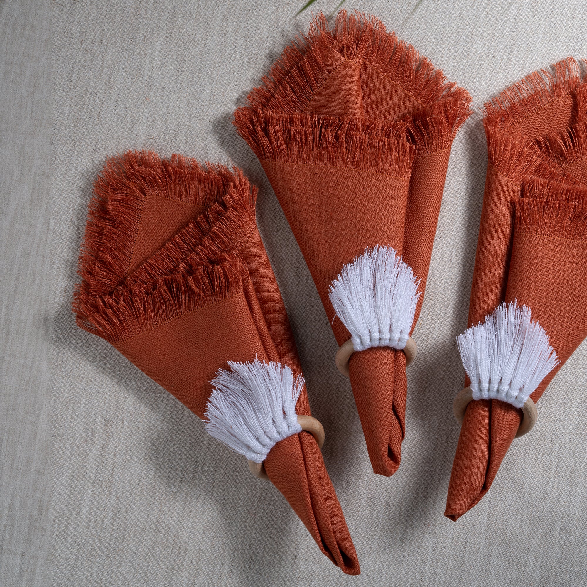 Close-up of the fringed edge on rust pure linen dinner napkins
