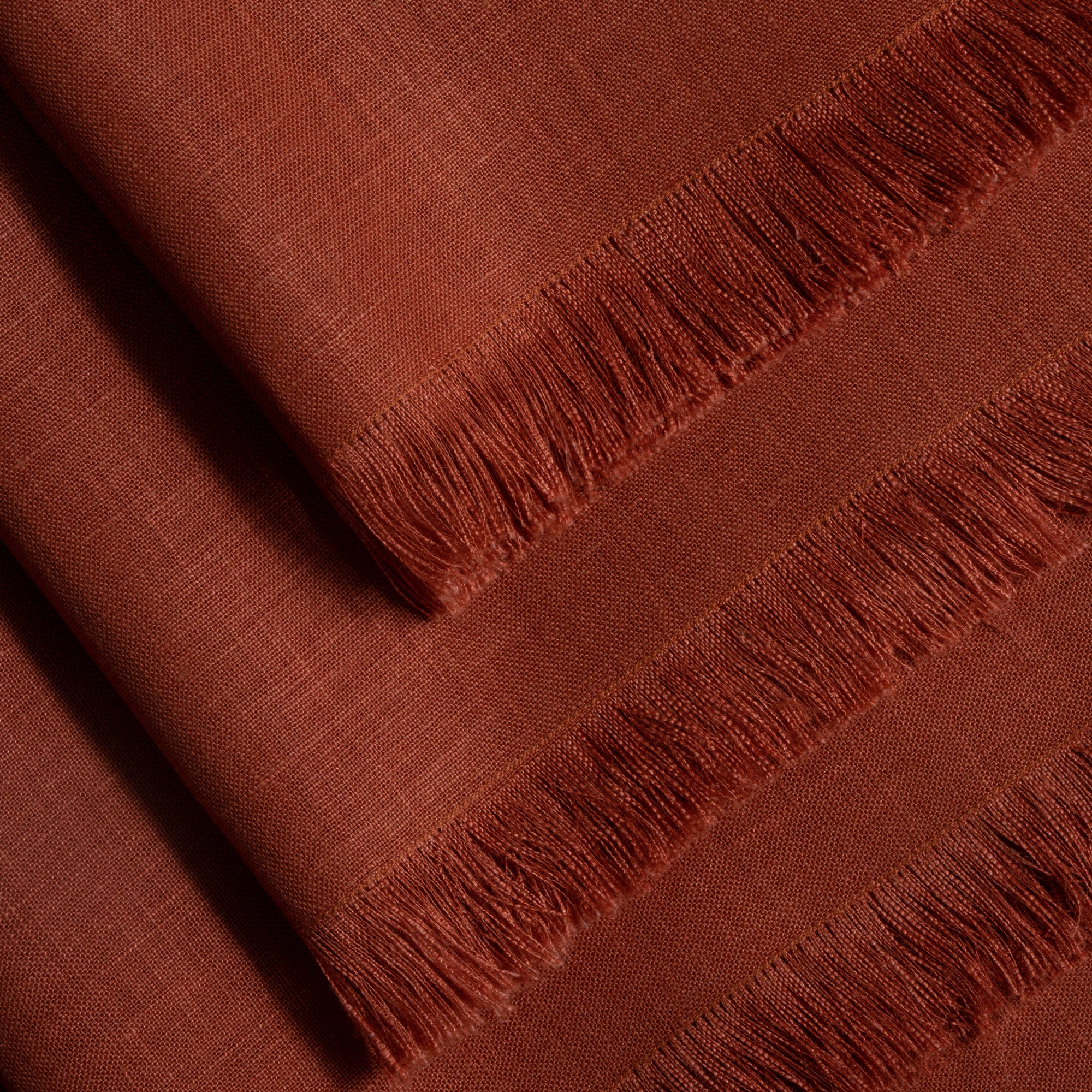 Rust pure linen dinner napkins folded to show fabric texture