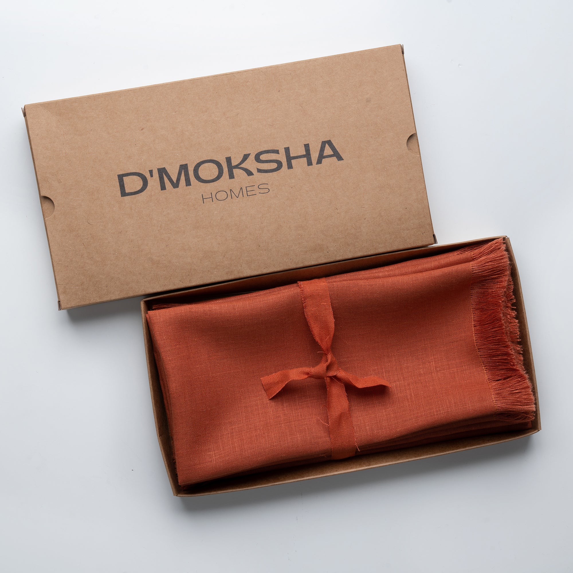 Rust pure linen dinner napkins in a set table setting
