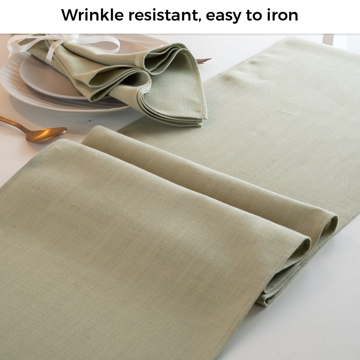 Sage green faux linen table runner folded to show fabric texture