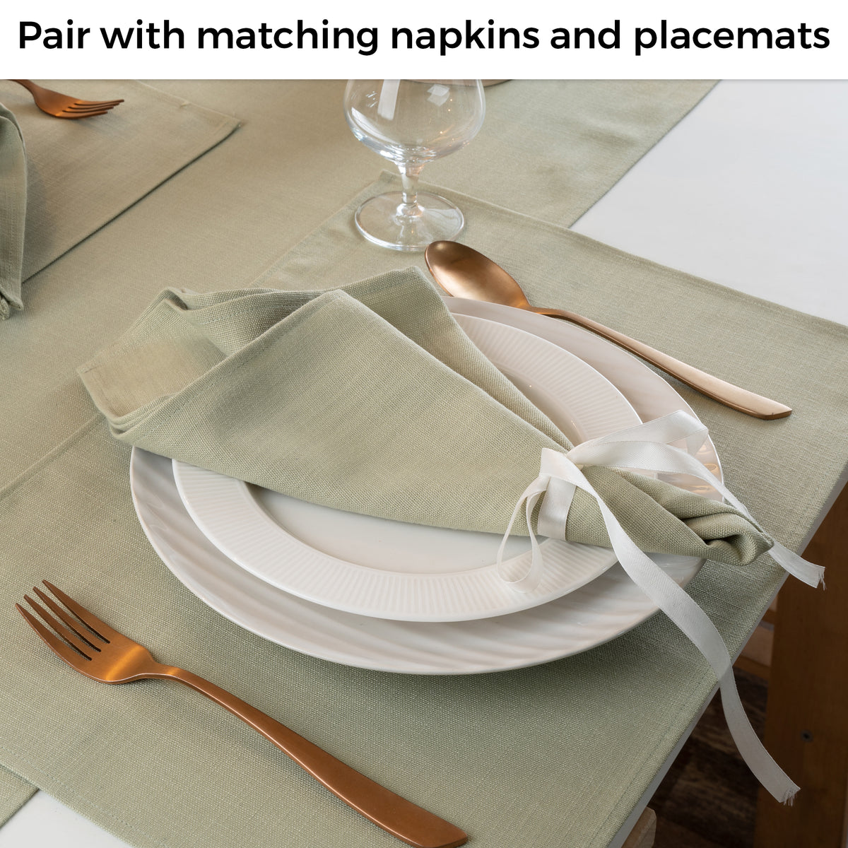 Sage green faux linen table runner in a set table setting
