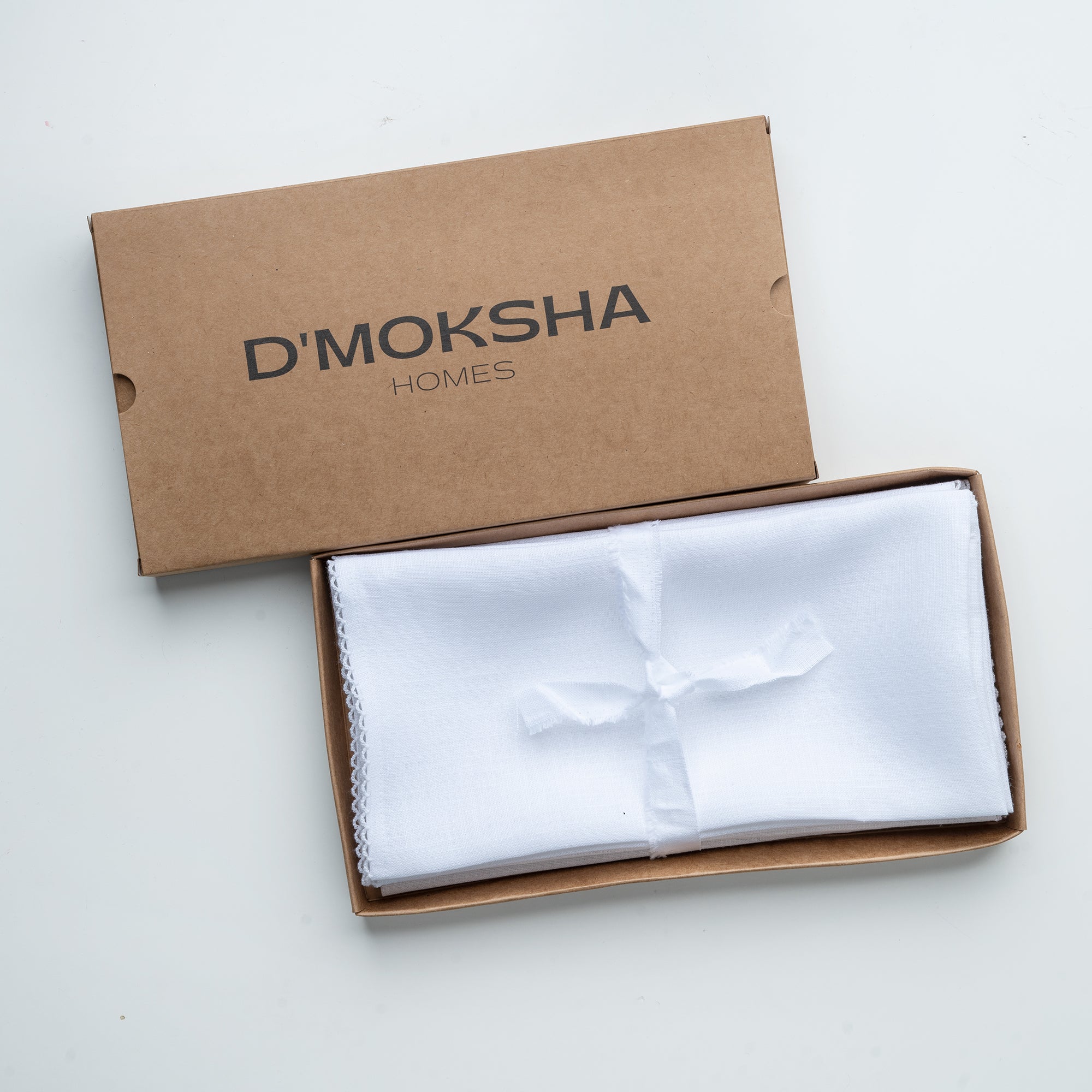 White and white pure linen dinner napkins in a set table setting