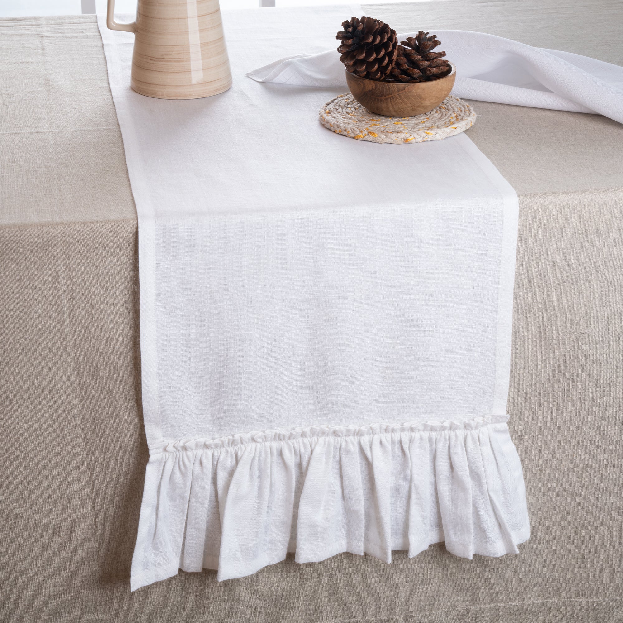 White pure linen table runner styled on a dining table