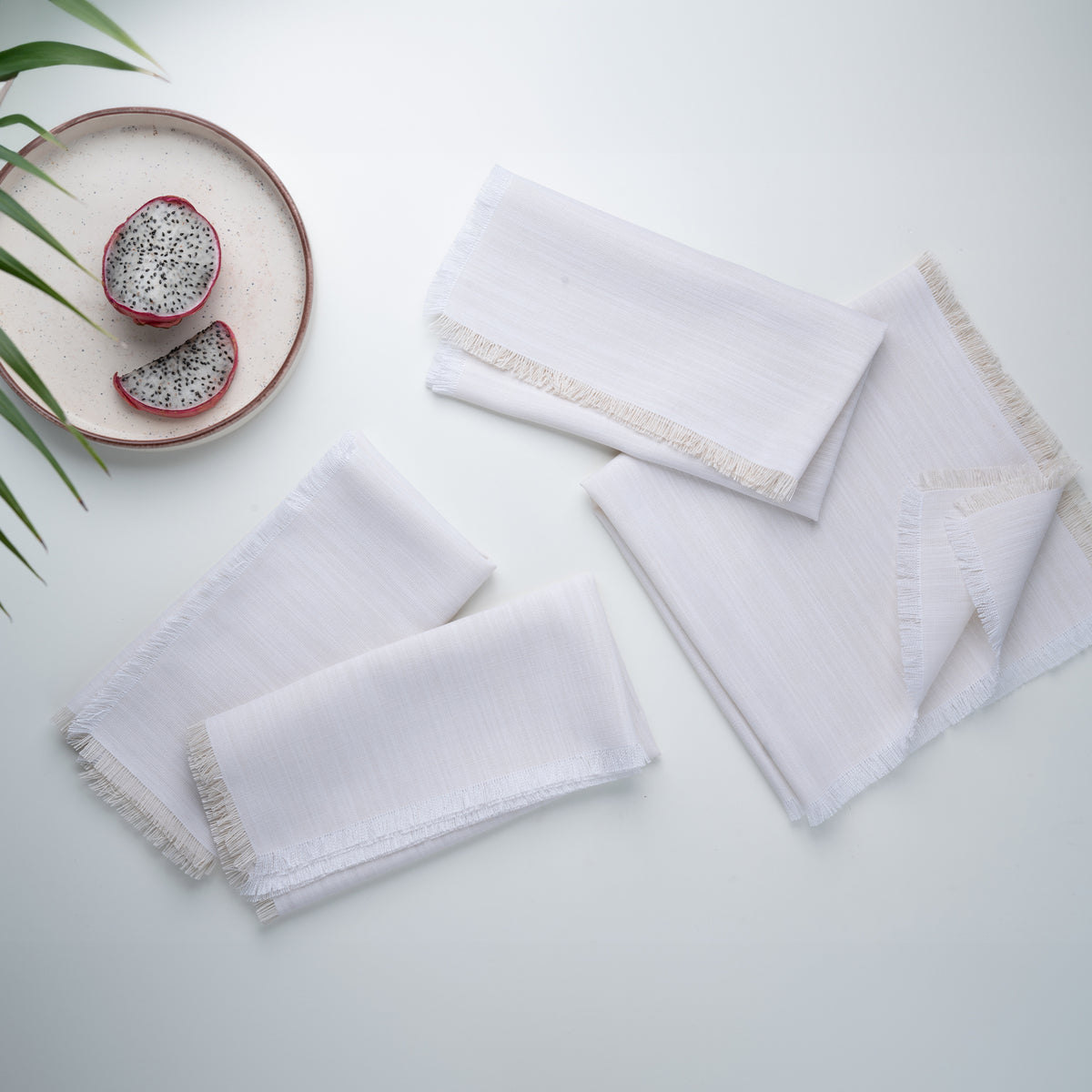 Chambray cream and white faux linen dinner napkins styled on a dining table