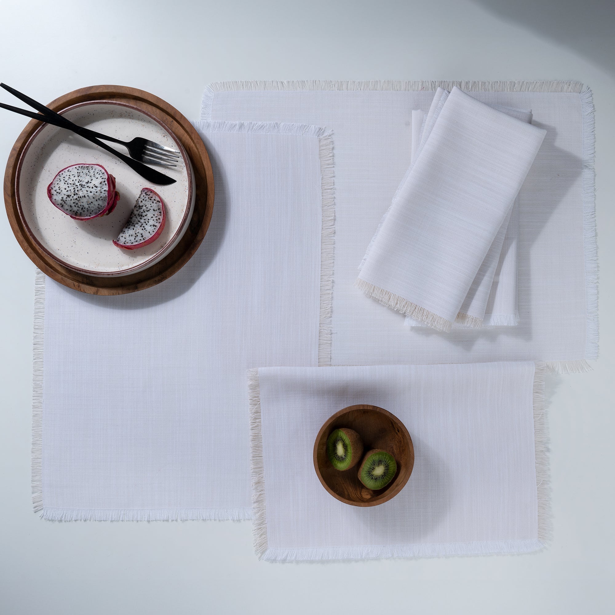 Close-up of the fringed edge on chambray cream and white faux linen placemats