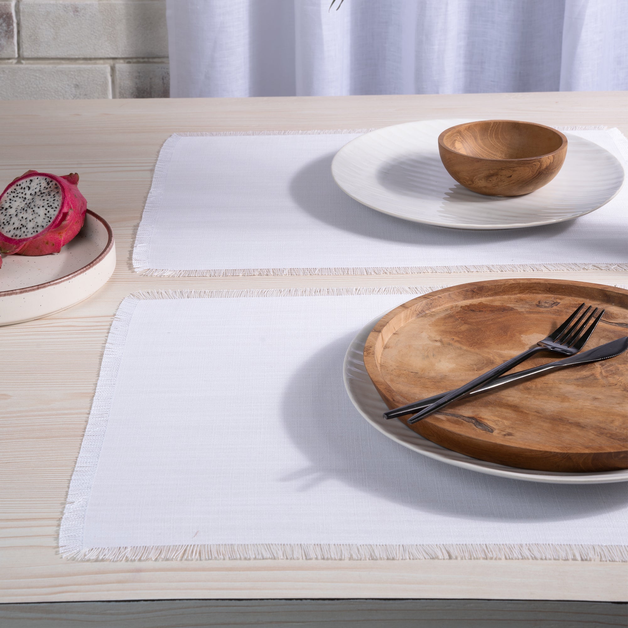 Chambray cream and white faux linen placemats folded to show fabric texture