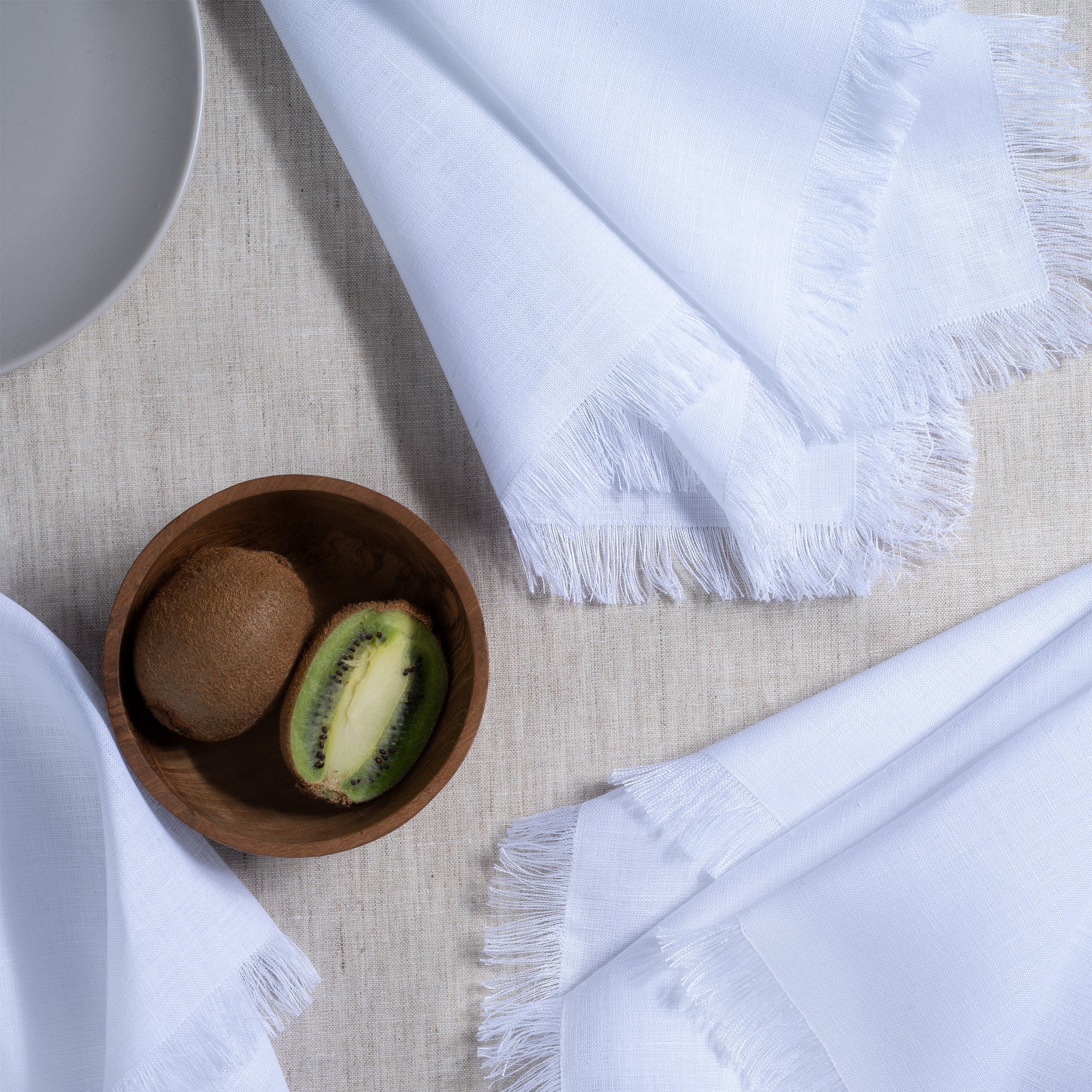 White pure linen dinner napkins styled on a dining table
