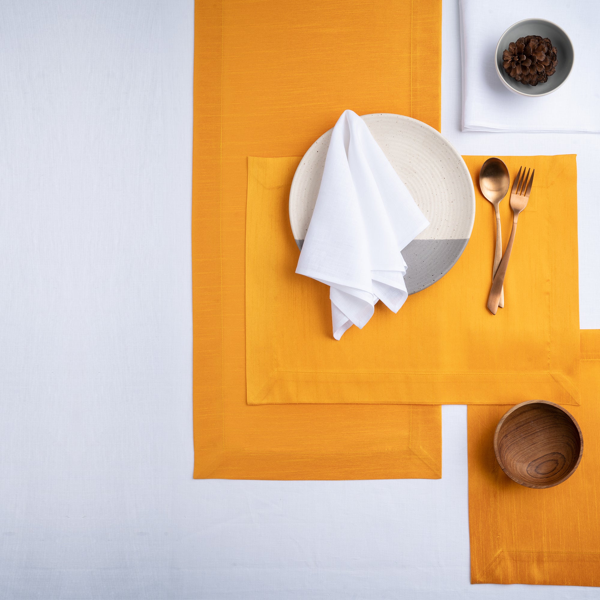 Close-up of the mitered corners on yellow Luxe Shine placemats