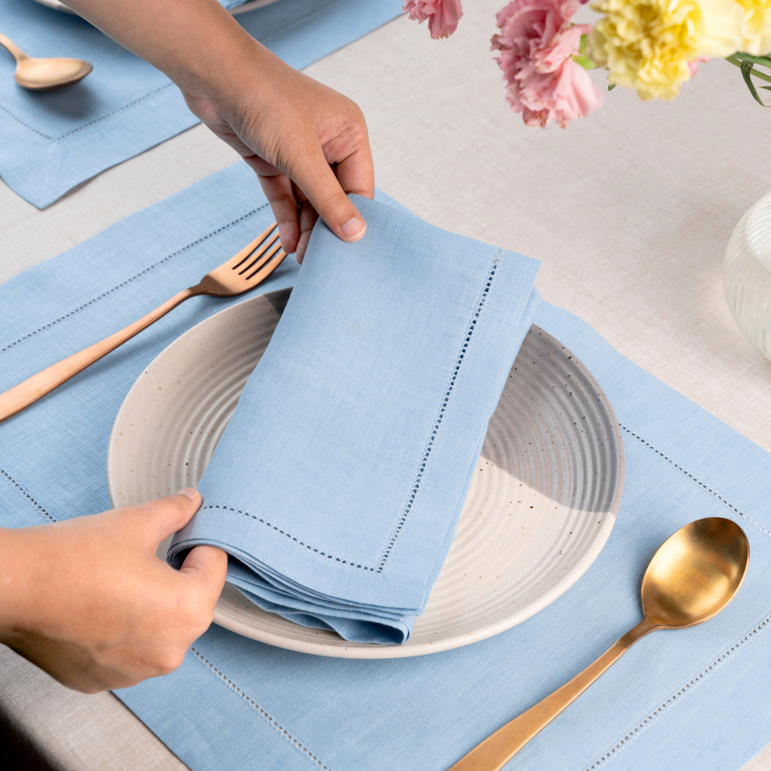 Powder blue pure linen dinner napkins styled on a dining table