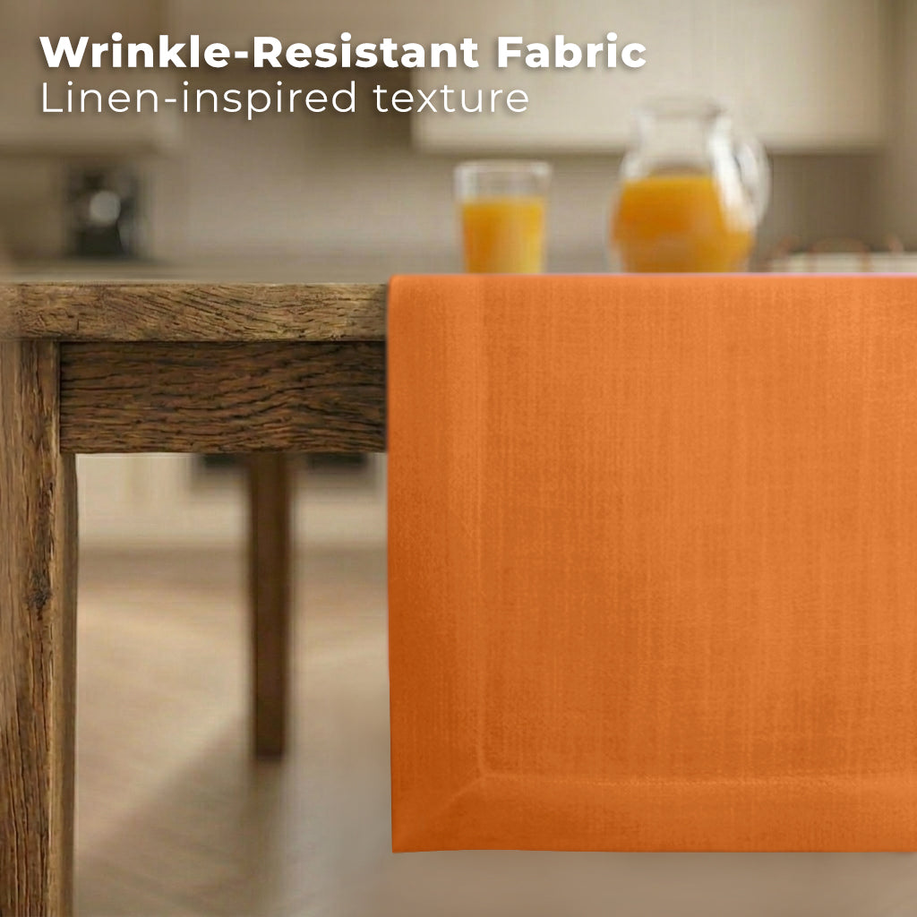 Orange faux linen table runner styled on a dining table